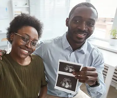 Happy-couple-with-baby-ultrasound-after-ivf-treatment-abroad