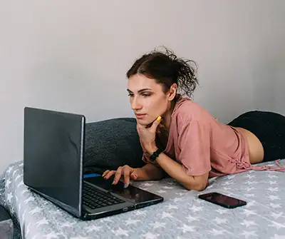 Woman-researching-ivf-facts-on-her-laptop