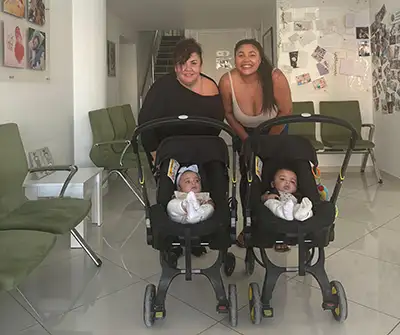 Smiling-female-couple-with-babies-after-artificial-insemination